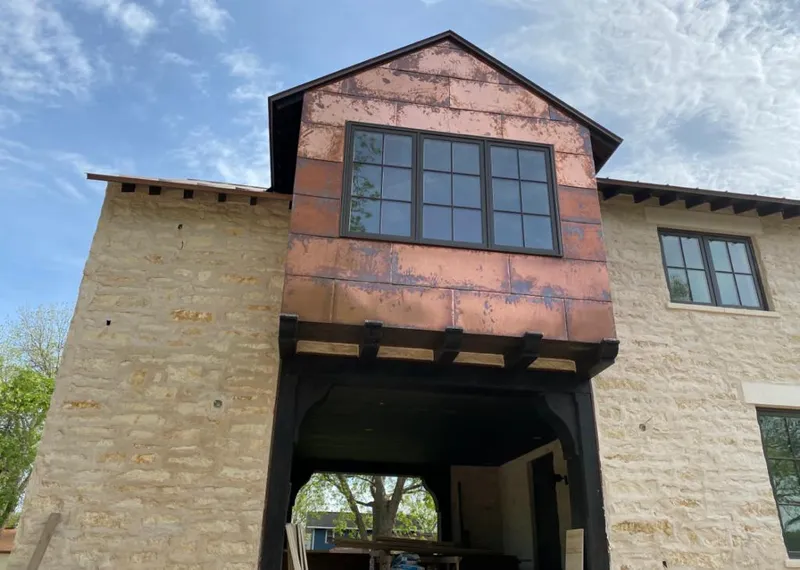 Copper metal panel facade on a stone building for Skylight Installation in Pound Ridge
