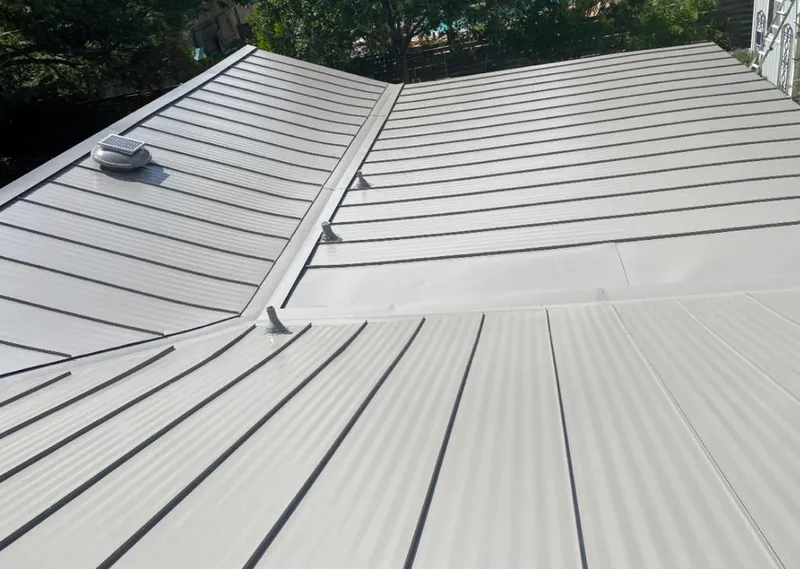 Solar attic fan installed on a metal roof for Roof Ventilation in Pound Ridge